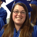 Photo of Ashley in cap and gown before Fall 2016 Commencement Ceremony.